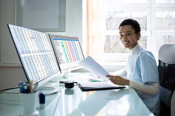 man seated at computer smiling