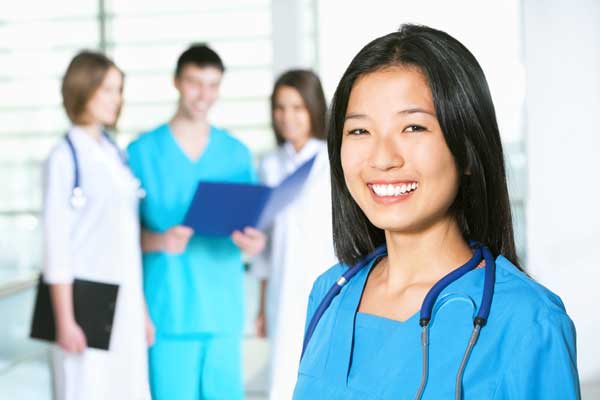 female smiling in scrubs
