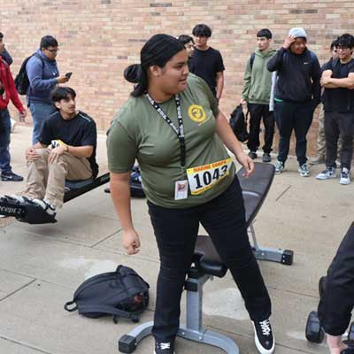 Students prepare to sit on weight benches as part of the Battle of the Branches event
