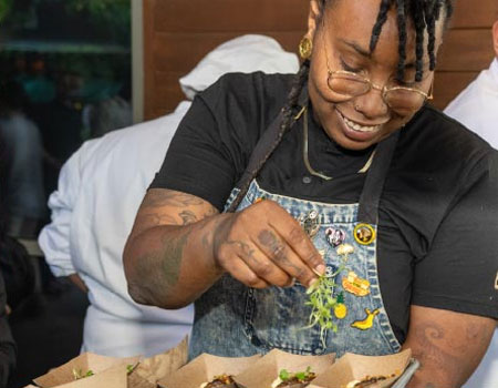 A chef prepares a meal at Bits and Bites