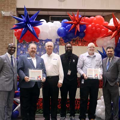 Veterans pose with Dallas College leadership at the Veterans Resource Fair