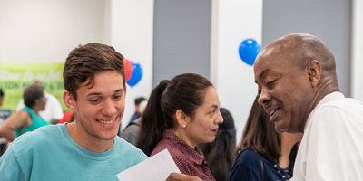 first time student smiling with Dallas College staff