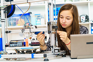 Student putting together a mechanical contraption
