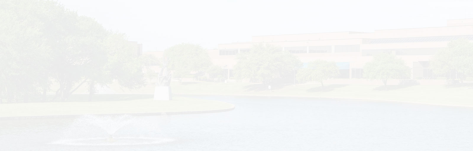 A faded photo of the North Lake campus at a distance