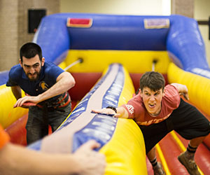 Students race each other in a large inflatable game at Eastfield