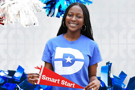 A student wearing a Dallas College T-shirt holds a small 