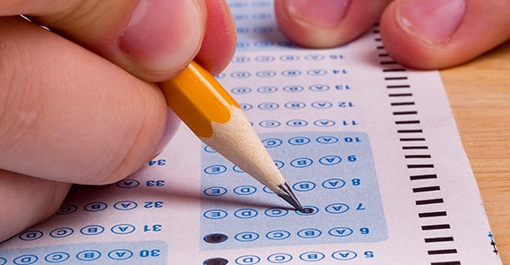 Close-up of a hand filling scantron.