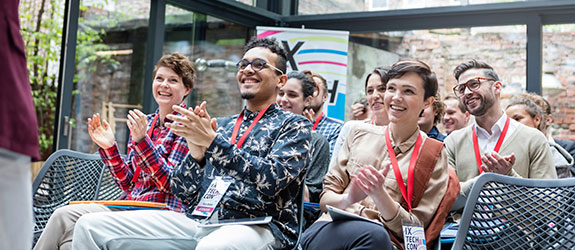 Students clapping at a conference