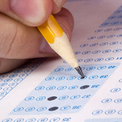 student filling out a scantron sheet