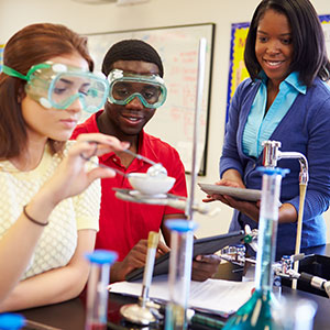 Image of students conducting an experiment with teacher supervision