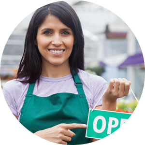 Young business owner holding Open sign