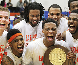 Eastfield basketball players cheer as they hold their championship trophy