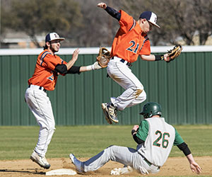 An Eastfield player jumps to grab a ball over a sliding base runner
