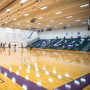 Image of the Richland gym with basketball players competing in a game on the far end