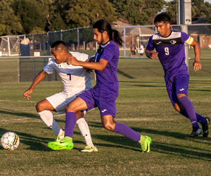 Richland soccer players try to capture the ball from another player