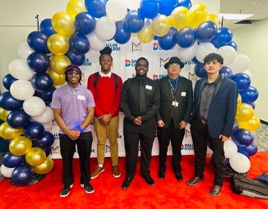 Students at the MAP Summit pose while standing under a balloon arch